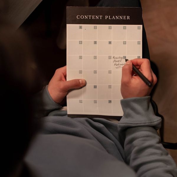 A well-organized desk with a planner showing a daily routine.